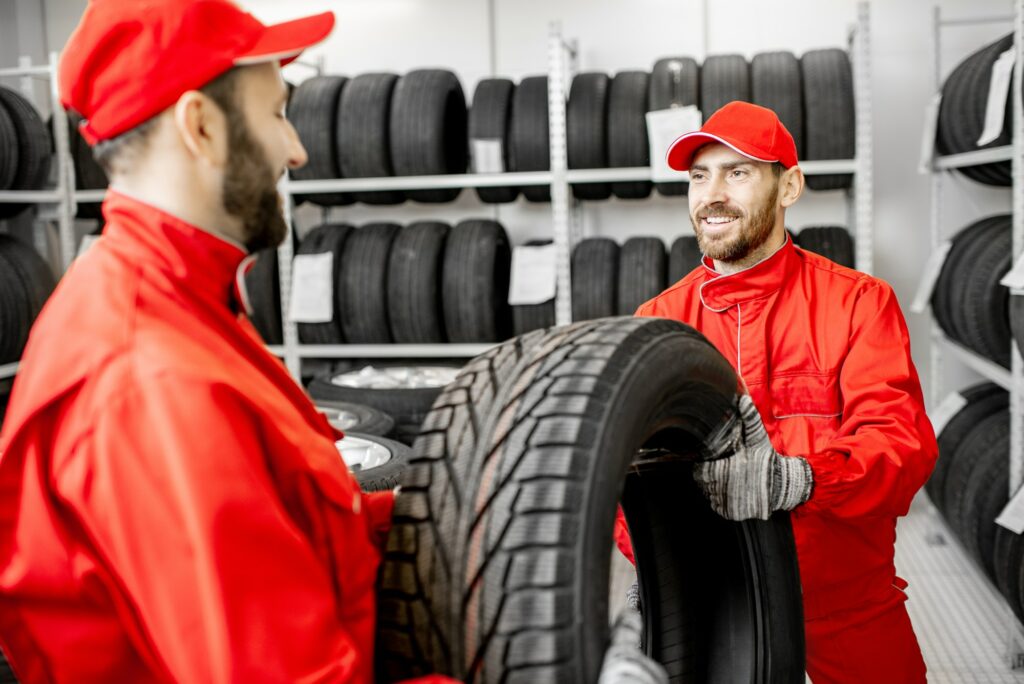 Men working in the warehouse with tires